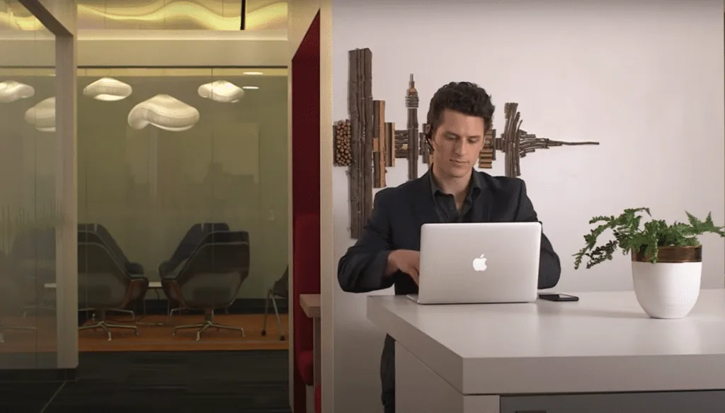 Một người đàn ông đeo tai nghe Voyager 5200 làm việc