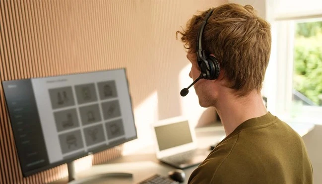 impact-mb-pro---man-working-on-desktop-wearing-headset